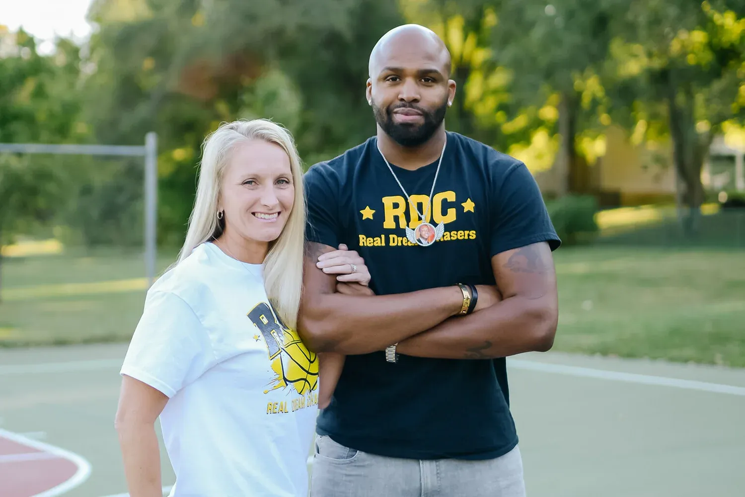 Alissa and Ronnie Powell standing together on a basketball court