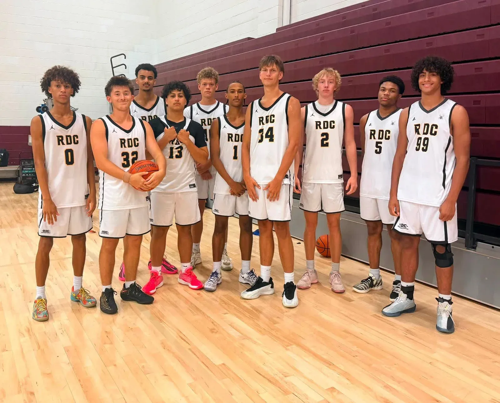 RDC basketball team in white uniforms on a gym court